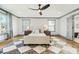 Bright bedroom featuring hardwood floors, a ceiling fan, natural light, and an ensuite bathroom at 2357 Lynn Iris Dr, Decatur, GA 30032