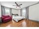 Bright bedroom featuring hardwood floors, a ceiling fan, natural light, and a comfortable armchair for relaxation at 2357 Lynn Iris Dr, Decatur, GA 30032