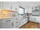 Well-lit kitchen with white cabinets, sleek black hardware, and stainless steel appliances at 2357 Lynn Iris Dr, Decatur, GA 30032