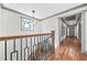 Upstairs landing featuring wood floors, geometric pendant lighting and views of other rooms at 2357 Lynn Iris Dr, Decatur, GA 30032