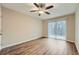 Bright bedroom with wood floors, ceiling fan, and sliding doors leading to a patio at 2436 Wilshire Ct, Decatur, GA 30035