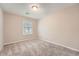 Simple carpeted bedroom bathed in natural light from a single window at 2436 Wilshire Ct, Decatur, GA 30035