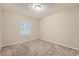 Cozy bedroom with neutral walls, carpet flooring, and a window providing natural light at 2436 Wilshire Ct, Decatur, GA 30035