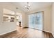Open dining area featuring wood floors, a modern light fixture, and access to the kitchen at 2436 Wilshire Ct, Decatur, GA 30035