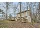 Exterior view of home with multiple decks amidst a wooded landscape at 2436 Wilshire Ct, Decatur, GA 30035