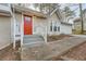 Inviting front entrance with a bright red door, gray stairs, and a walkway to the garage at 2436 Wilshire Ct, Decatur, GA 30035