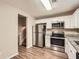 Well-lit kitchen featuring stainless steel appliances and granite countertops, complemented by hardwood flooring at 2436 Wilshire Ct, Decatur, GA 30035