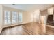 Spacious living room with wood floors, large windows, and a staircase leading to the upper level at 2436 Wilshire Ct, Decatur, GA 30035