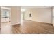 Bright and airy living room featuring wood floors, vaulted ceiling, and a view into the kitchen area at 2436 Wilshire Ct, Decatur, GA 30035