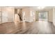 Spacious living room with vinyl floors, a staircase, and a dining area next to the kitchen at 2436 Wilshire Ct, Decatur, GA 30035