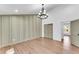 Bright bedroom with hardwood floors and an accent wall with a chandelier at 2681 Beckwith Se Trl, Marietta, GA 30068