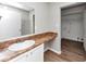 Bathroom featuring wide mirror, wood-look floors, and view into laundry room at 346 Henry Aaron Sw Ave, Atlanta, GA 30310