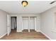 Cozy bedroom with wood floors, neutral walls, open closet and a window view at 346 Henry Aaron Sw Ave, Atlanta, GA 30310