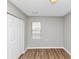 Bright bedroom with hardwood floors, neutral walls, and closet with double doors at 346 Henry Aaron Sw Ave, Atlanta, GA 30310