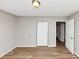 Empty bedroom with wood-look floors, a closet, and views to other rooms at 346 Henry Aaron Sw Ave, Atlanta, GA 30310