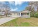 Charming single-story home with a welcoming front porch and covered parking on a grassy lot at 346 Henry Aaron Sw Ave, Atlanta, GA 30310