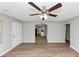 Living room features sleek wood floors, neutral paint, ceiling fan and archway to kitchen at 346 Henry Aaron Sw Ave, Atlanta, GA 30310