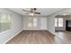 Inviting living room featuring sleek wood floors, abundant natural light, and a ceiling fan at 346 Henry Aaron Sw Ave, Atlanta, GA 30310