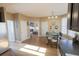 Sun-lit dining area features a glass table set for six with hardwood floors and views to living area at 642 Towering Pine Trl, Lawrenceville, GA 30043