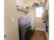 Well-equipped laundry room with modern washer and dryer, storage shelves, and wood flooring at 642 Towering Pine Trl, Lawrenceville, GA 30043