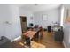 Bright home office with hardwood floors, a large desk, and natural light from the window at 642 Towering Pine Trl, Lawrenceville, GA 30043