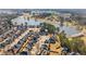 Aerial view of a neighborhood with a scenic pond, showcasing the community layout and surrounding landscape at 644 Crystal Cove Ct, Loganville, GA 30052