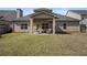 Backyard featuring a covered patio with furniture on a well maintained lawn at 644 Crystal Cove Ct, Loganville, GA 30052