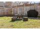 Backyard featuring a charming fire pit area with cushioned seating and a grill at 644 Crystal Cove Ct, Loganville, GA 30052