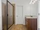 Modern bathroom features a glass enclosed shower, and a granite sink at 644 Crystal Cove Ct, Loganville, GA 30052