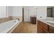 Bright bathroom featuring a jetted tub, shower, and granite countertops at 644 Crystal Cove Ct, Loganville, GA 30052