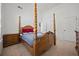 Spacious bedroom featuring a wooden four-poster bed, neutral carpet and light walls at 644 Crystal Cove Ct, Loganville, GA 30052