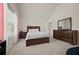 Comfortable bedroom featuring neutral tones, vaulted ceiling and natural light at 644 Crystal Cove Ct, Loganville, GA 30052