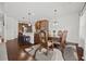 Stylish dining room adjacent to the kitchen featuring a decorative chandelier at 644 Crystal Cove Ct, Loganville, GA 30052