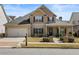 Charming two-story home with a manicured front yard, inviting porch, and attached two-car garage at 644 Crystal Cove Ct, Loganville, GA 30052