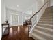 Inviting foyer with hardwood floors, a staircase, and views into the formal living room at 644 Crystal Cove Ct, Loganville, GA 30052