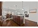 Open-concept kitchen featuring a granite island, breakfast bar, and hardwood flooring at 644 Crystal Cove Ct, Loganville, GA 30052