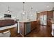 Spacious kitchen with stainless steel appliances and granite countertops open to the living room at 644 Crystal Cove Ct, Loganville, GA 30052