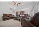 Spacious living room with a stone fireplace, plush carpeting, and ample seating at 644 Crystal Cove Ct, Loganville, GA 30052