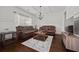 Elegant living room featuring coffered ceilings, dark wood floors, and a wall of windows at 644 Crystal Cove Ct, Loganville, GA 30052