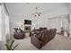 Spacious living room with a stone fireplace, plush carpeting, and ample seating at 644 Crystal Cove Ct, Loganville, GA 30052