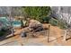 Playground nestled among mature trees offering a fun, safe space for children to play and enjoy the outdoors at 644 Crystal Cove Ct, Loganville, GA 30052