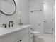 Renovated bathroom featuring a round mirror, modern vanity, and elegant fixtures, creating a spa-like retreat at 1772 Ascot Nw Run, Acworth, GA 30102