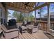 Inviting covered deck with comfortable wicker furniture, perfect for relaxing or entertaining outdoors at 1772 Ascot Nw Run, Acworth, GA 30102