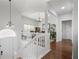 Bright entryway with white staircase, hardwood floors, and views into the dining area and other living spaces at 1772 Ascot Nw Run, Acworth, GA 30102