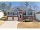 Beautiful two-story home with brick accents, a well-manicured lawn, and an inviting facade at 1772 Ascot Nw Run, Acworth, GA 30102
