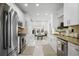 The kitchen features white cabinetry, stainless appliances, granite countertops and a cozy breakfast nook at 1772 Ascot Nw Run, Acworth, GA 30102