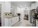 Well-lit kitchen featuring granite countertops, stainless appliances and white cabinets; a chef's dream at 1772 Ascot Nw Run, Acworth, GA 30102
