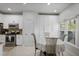 Bright kitchen boasts modern appliances, granite countertops, white cabinetry, and a cozy breakfast nook at 1772 Ascot Nw Run, Acworth, GA 30102