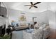 This living room features neutral paint, a fireplace, ceiling fan, and hardwood floors at 1772 Ascot Nw Run, Acworth, GA 30102