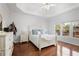 Relaxing main bedroom with tray ceilings, hardwood floors, and natural light from a window overlooking the backyard at 1772 Ascot Nw Run, Acworth, GA 30102